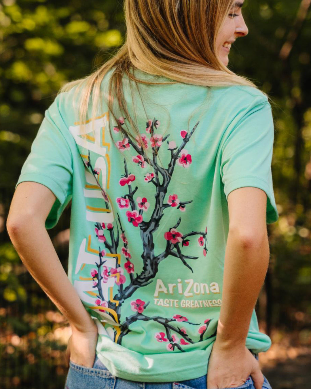 Girl wearing AriZona x GOAT USA Cherry Blossom T-Shirt with hands in the pockets