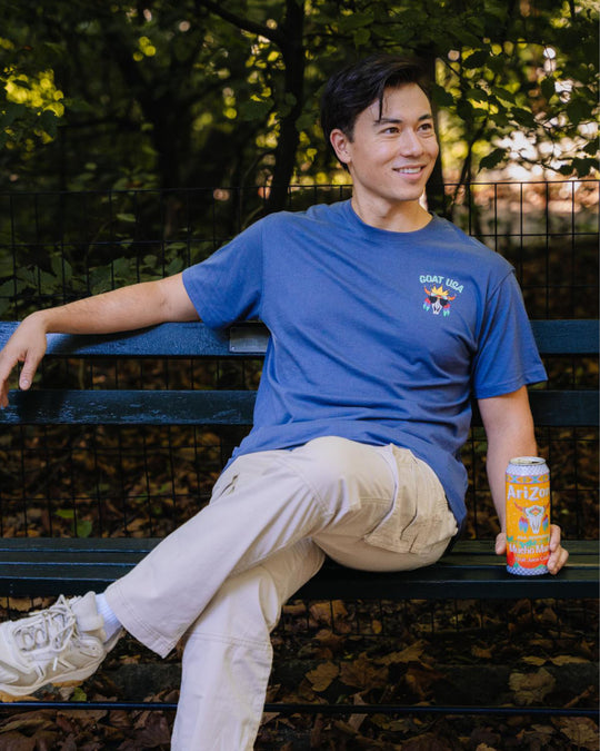 Guy sitting on park bench wearing AriZona skull goat t-shirt