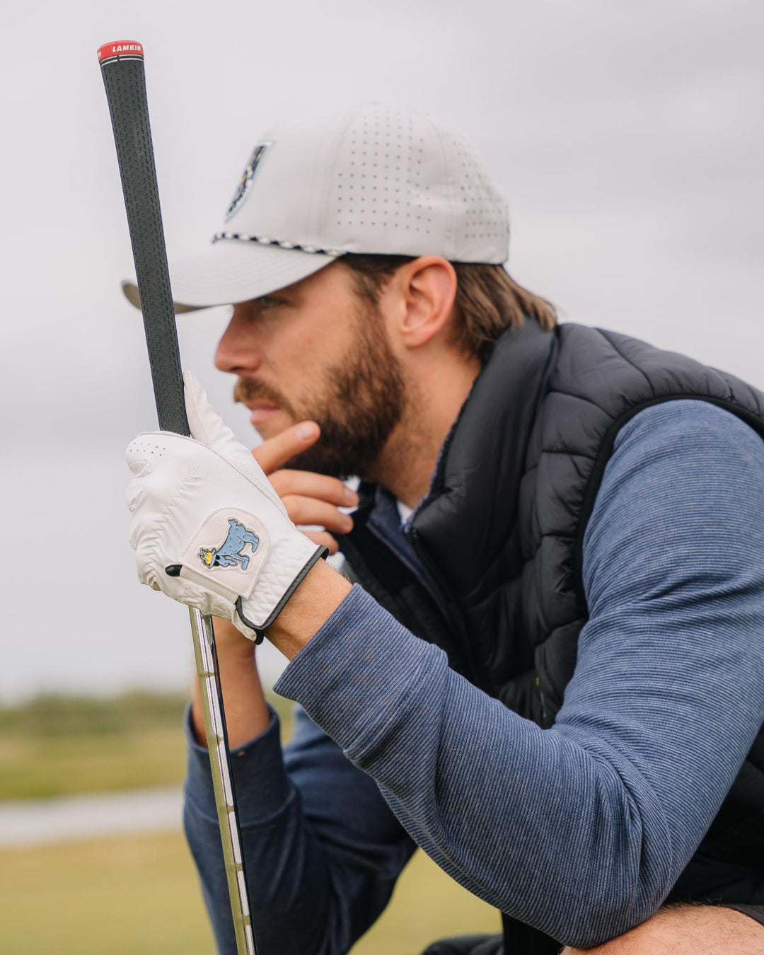 Man thinking about his golf shot while crouching down