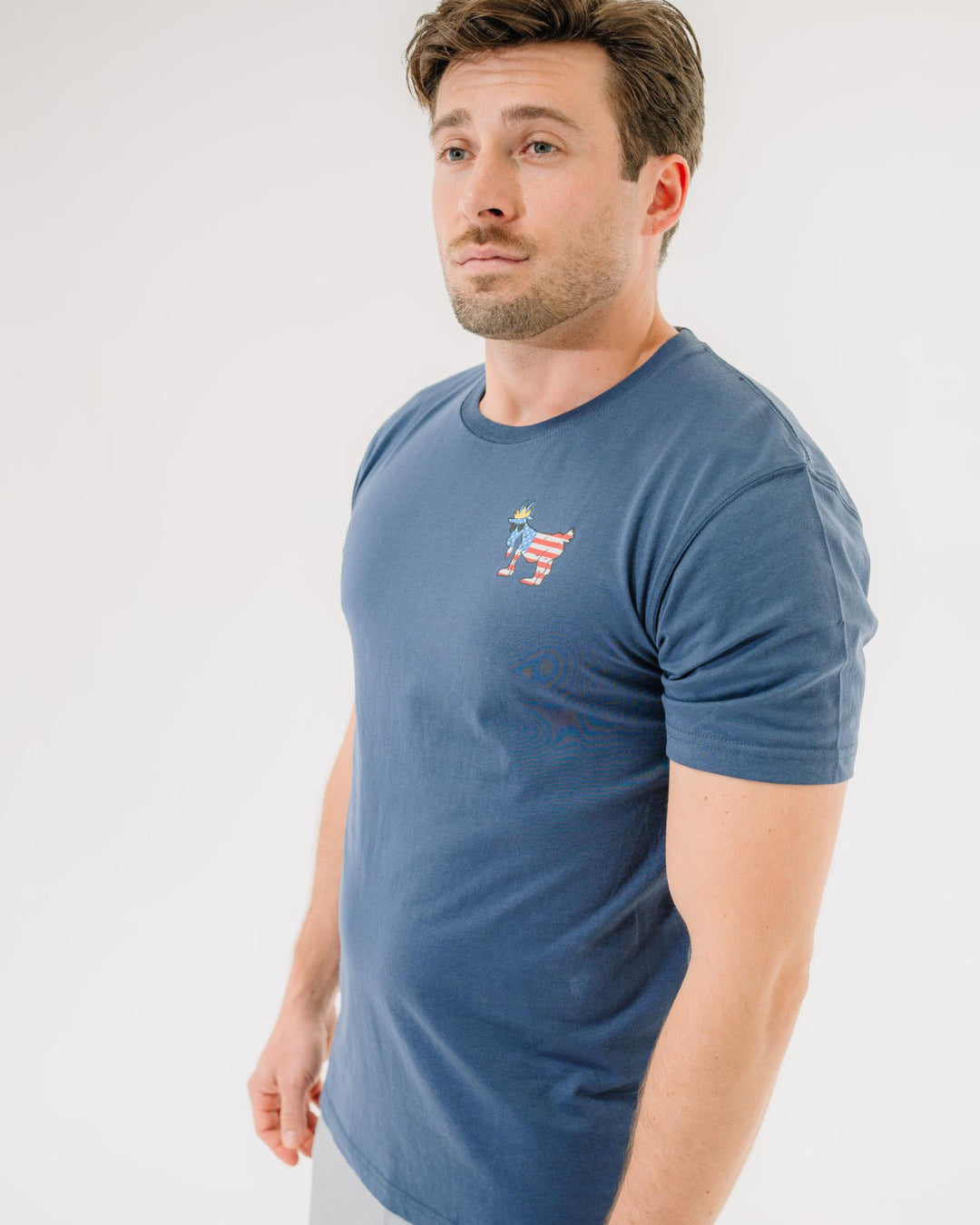 Male model wearing navy Freedom T-Shirt#color_navy