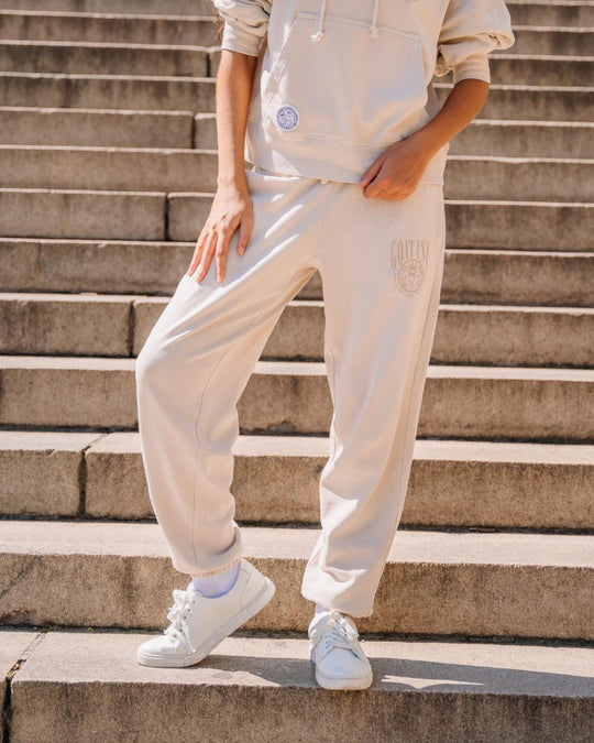 Image showcasing woman's sweatpants while she is standing on steps outdoors#color_sandshell