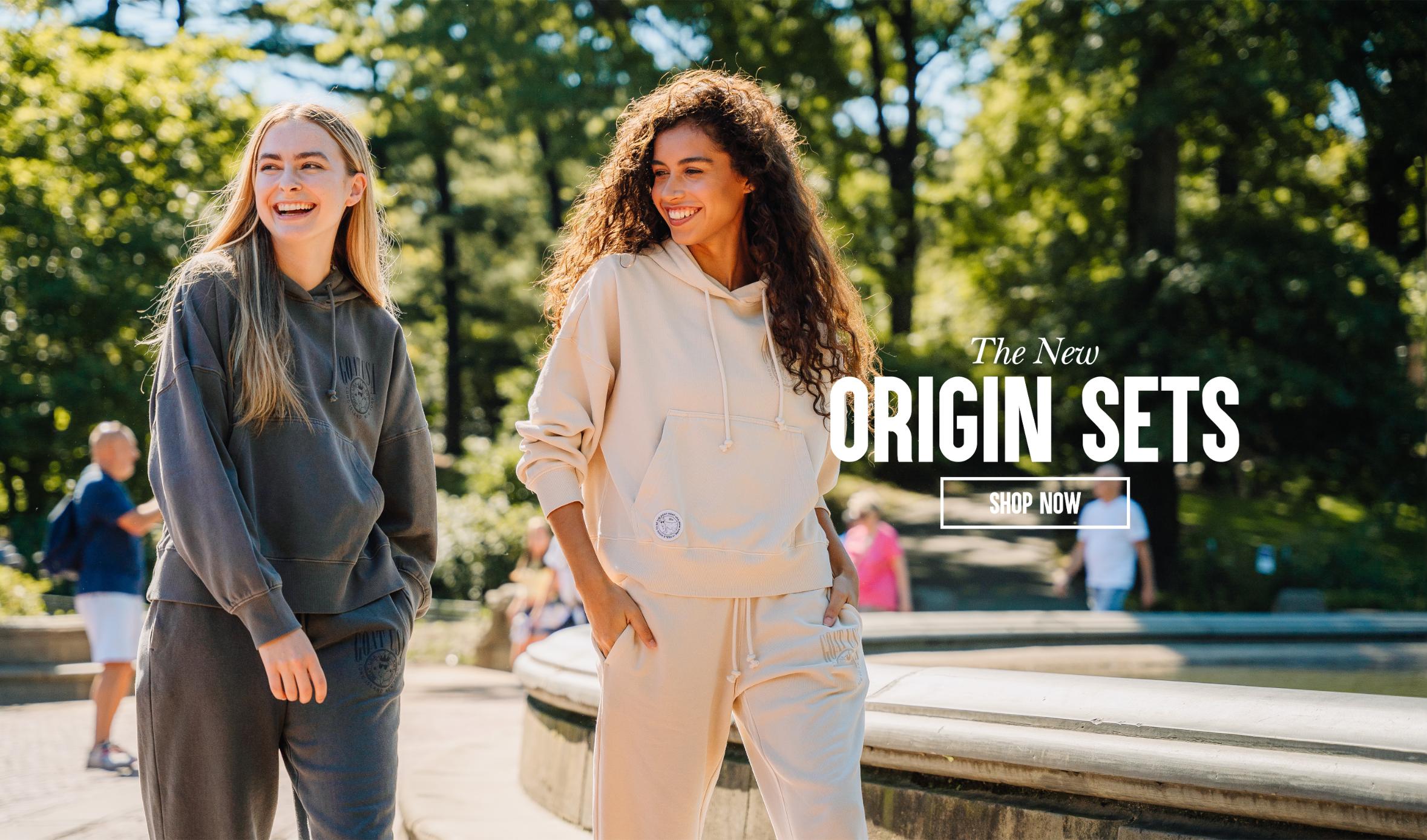 Two women walking in a park on a sunny day