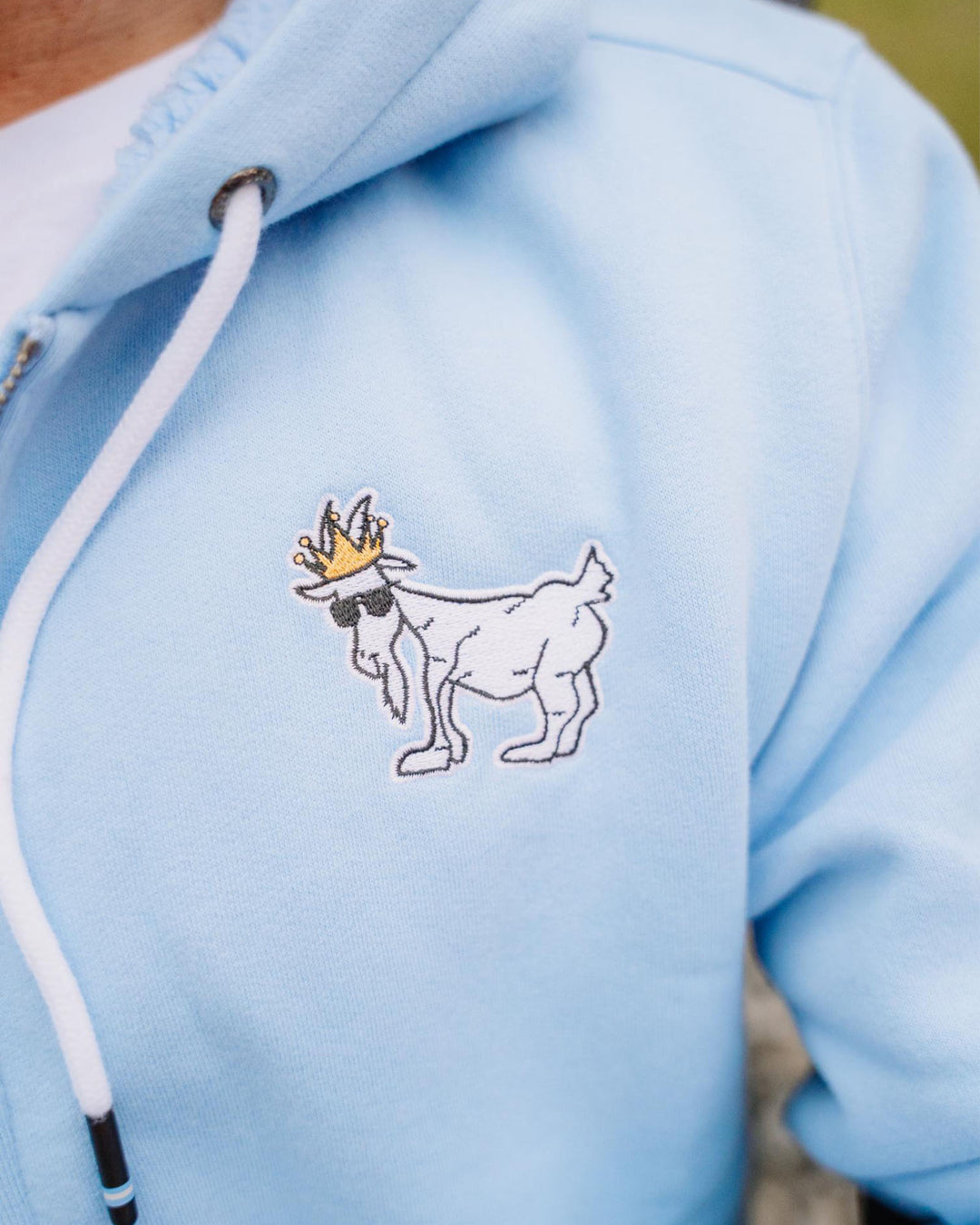 Close-up of logo on Carolina Blue sherpa-lined full-zip sweatshirt#color_carolina-blue