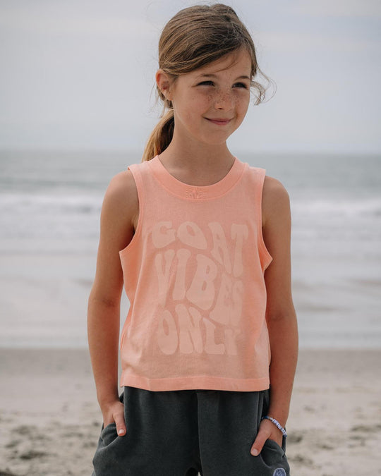 Girl smiling on the beach in peach cream tank top#color_peach-cream