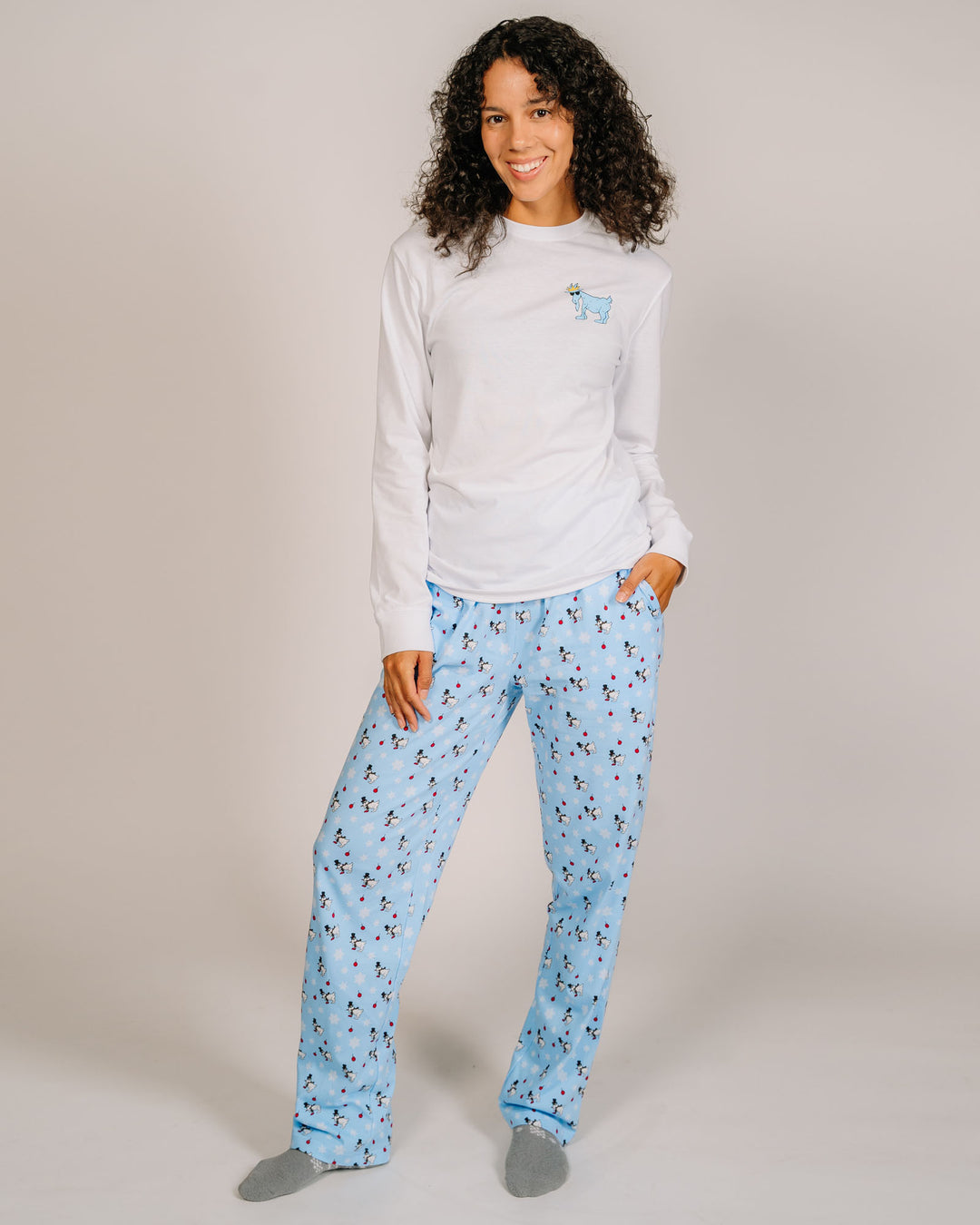 Woman posing in snowman pajama pants