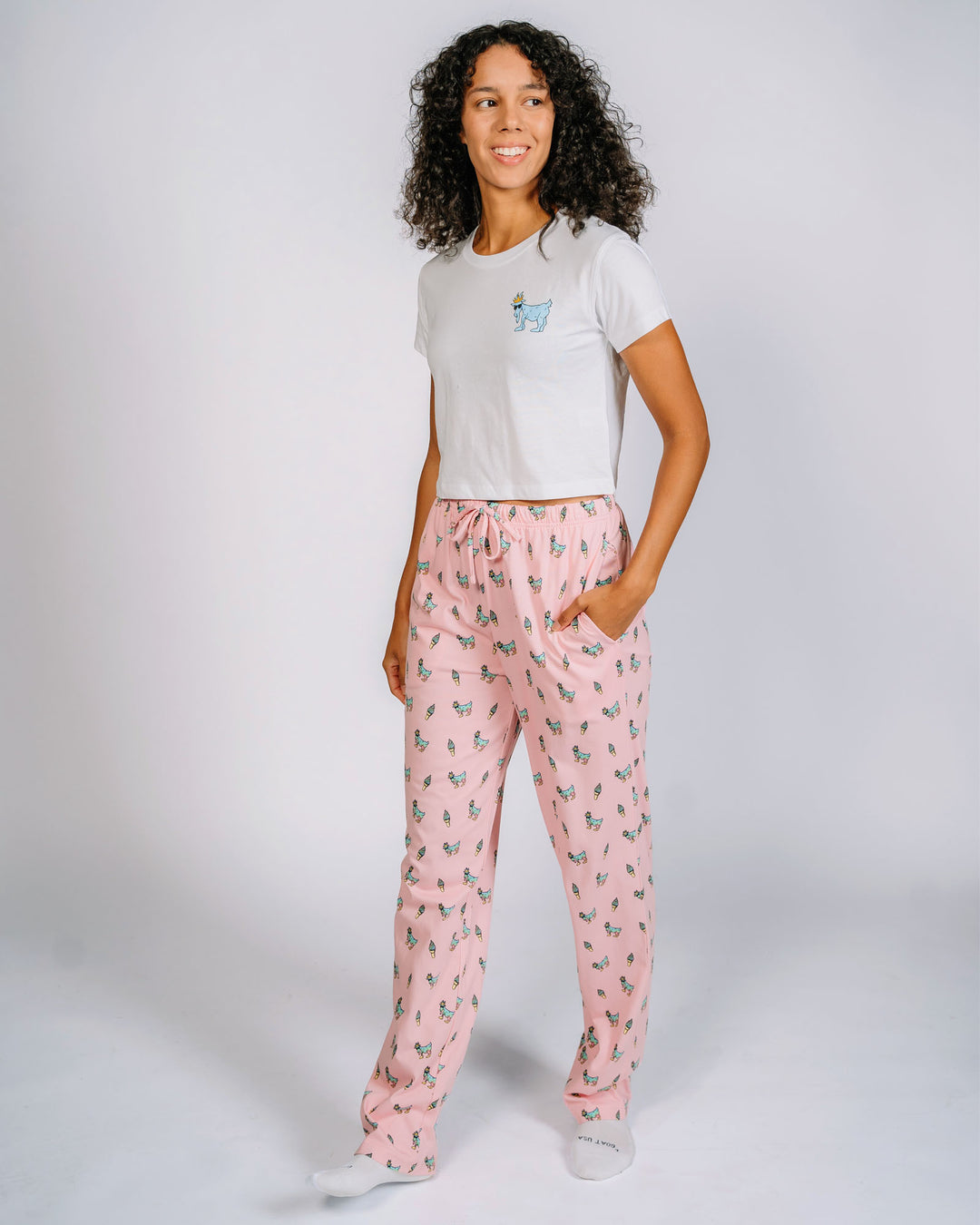 Female model posing in pink ice cream goat pajama pants