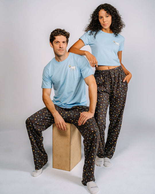 Man and woman posing in pajama pants with goats, teddy bears, stars and moons